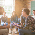 017b25bfbcef4497a8a9f798a242f000 multiple people sitting in a circle, support group